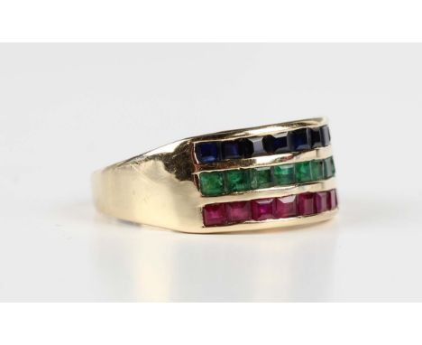 A gold, ruby, emerald and sapphire ring in a three row design, mounted with square cut gemstones, detailed '14K', weight 2.5g