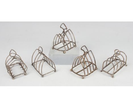 A pair of late Victorian silver arched four-division toast racks, Sheffield 1896 by James Deakin &amp; Sons, height 9cm, and 