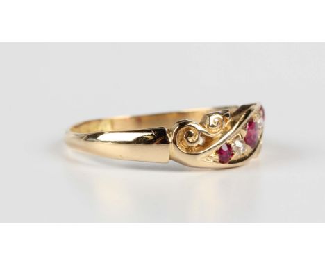 An Edwardian 18ct gold, ruby and diamond ring, mounted with three cushion cut rubies alternating with two cushion cut diamond