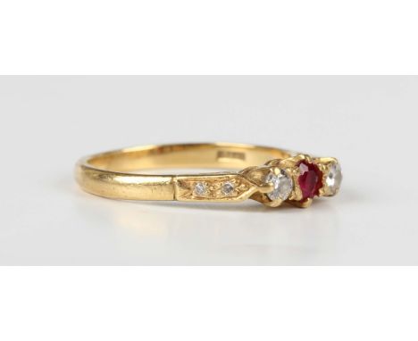 An 18ct gold, ruby and diamond three stone ring, claw set with the oval cut ruby between two circular cut diamonds, with diam