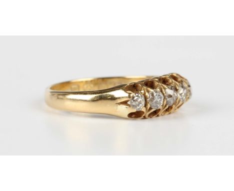 A Victorian 18ct gold and diamond ring, claw set with a row of five cushion cut diamonds, Birmingham 1886, weight 3.4g, ring 