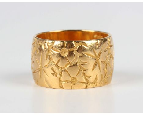 A 22ct gold wide band wedding ring with foliate engraved decoration, London 1966, weight 15.8g, ring size approx O1/2.Buyer’s