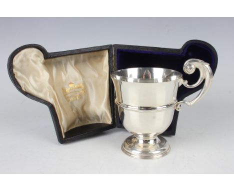 An Edwardian silver christening tankard of girdled 'U' form with scroll handle and circular foot, London 1901 by Wakeley &amp