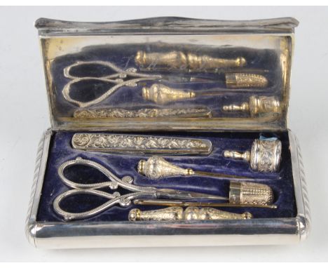 A mid-19th century Dutch silver nécessaire of curved rectangular form, the hinged lid engraved with a church and buildings fr