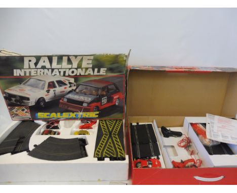 Three large scale Scalextric sets: the Daytona 24 hour, a road racing set and Rally Internationale, unchecked. 