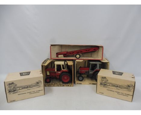 Ertl Toys - two boxed Massey Ferguson 1/16 scale tractors plus a boxed portable elevator and two others.