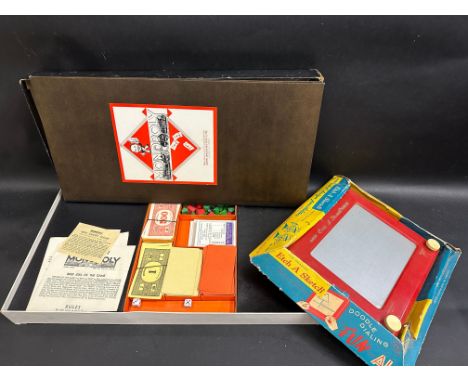 An early Monopoly game plus an Etch A Sketch in original box.