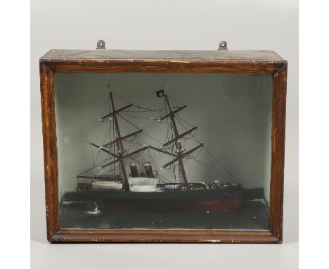 A wooden and painted model of a boat or schooner, with two masts and one with a flag and mounted in a glazed and wooden case.