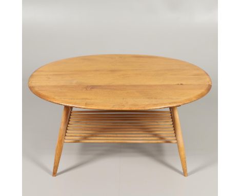 The light elm and beech supper table with an oval shaped top, supported on turned legs and with a slatted shelf underneath. T