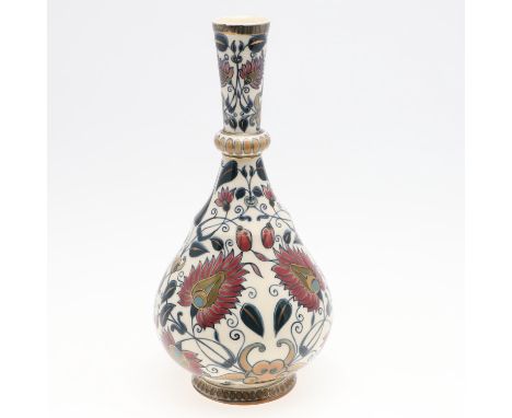 A bottle shaped vase painted with a Persian style design of flowers and leaves. Marked, 'Zsolnay Pecs'. 28cms high. *Conditio