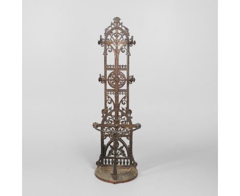 In the manner of Christopher Dresser, of tall narrow form with four coat hooks. The bottom section of bowed form with removab