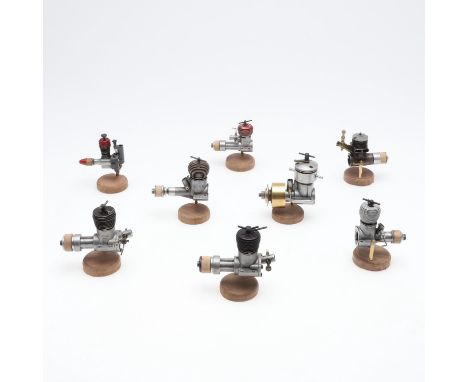 Eight various model engines including Jena (3), AMCO, Elfin 249, Gilbert 11, and various others. All mounted on wooden plinth