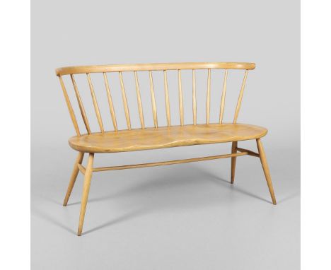 A vintage Ercol light elm and beech two seater 'love seat', Model No 450. With a twin saddle shaped seat and spindle back, wi