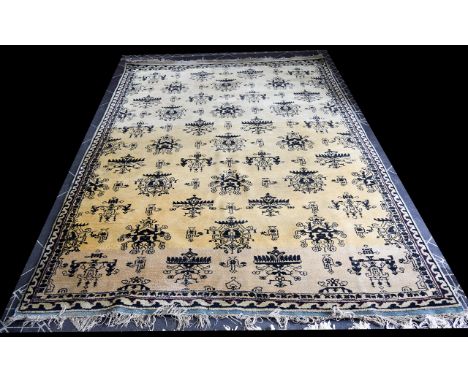 A Vintage Wool Rug Heavyweight woven wool rug with cream ground and repeated black ikat pattern throughout. Cotton fringing t