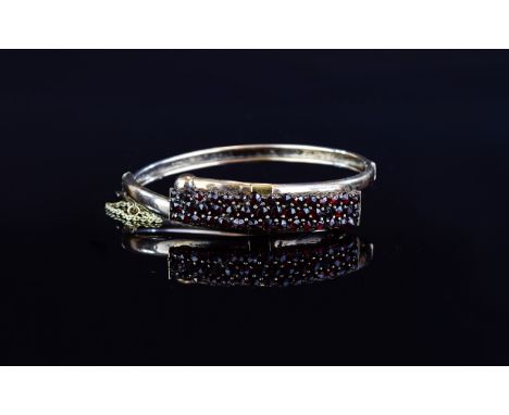 Antique Gold plated Garnet Set Bangle An unusual hinged bangle, circa late 19th/early 20th century with attached safety chain