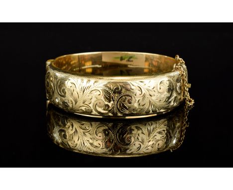 Edwardian Period 9ct Gold / Metal Core Hinged Bangle with Safety Chain. Chased Decorated to Front, Marked 9ct Gold - Metal Co