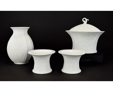 A Collection Of Kaiser Bisque Porcelain Items In 'Girlande' Design Four in total to include a pair of squat candlesticks, lid