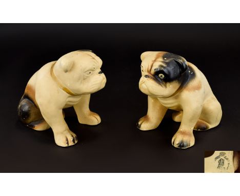 A Pair Of Vintage Ceramic Bulldog Figures Two unglazed earthenware figures in the form of seated Bulldogs, each painted with 