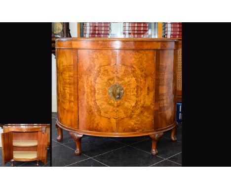 A 1920's Walnut Veneer Bow Front Cabinet Large two door cabinet in crescent from with ornate brass escutcheon detail, interna