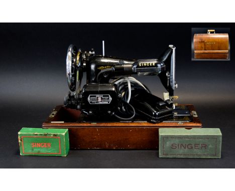 Vintage Singer Sewing Machine Finished in traditional black and gilt paint finish, in original lockable wooden carry case, co