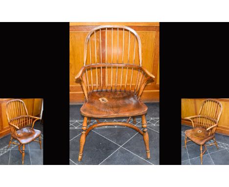 A Yew And Elm wood Windsor Armchair With Dished Seat. Circa 19th Century. Bow shaped strectchers. WOnderful period chair. Sea