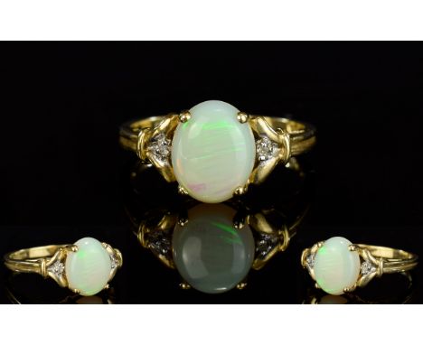 Ladies 9ct Gold Opal And Diamond Set Dress Ring. The central oval shaped Opal set with Diamonds to shoulders. Est Opal size 2