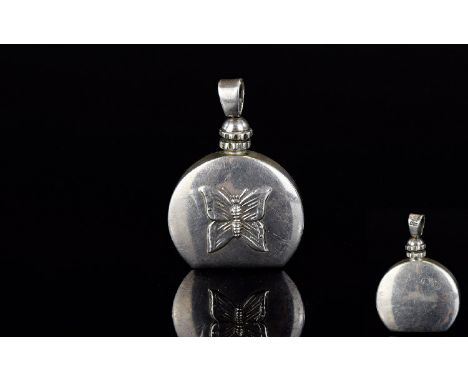 A Mexican Silver Decorative Perfume/Attar Pendant A small silver circular flask with flat base and top screw out detail for d