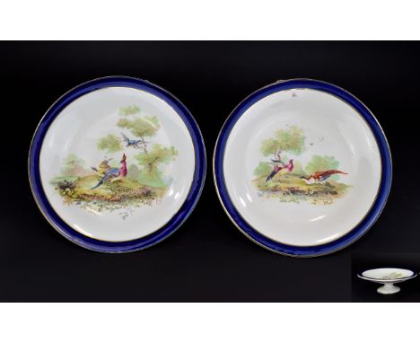 Royal Doulton A Pair Of Footed Shallow Dishes Two ceramic dishes each with cobalt blue border and central decoration depictin