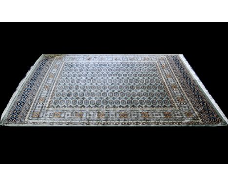 A Large Woven Silk Bokhara Carpet Ornate very large silk statement carpet with traditional lozenge and geometric repeat desig