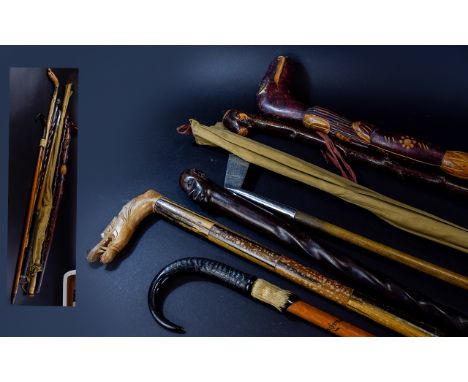 A Collection Of Antique Walking Sticks, Golf Putter And Fishing Rod Seven items in total to include carved African stick with