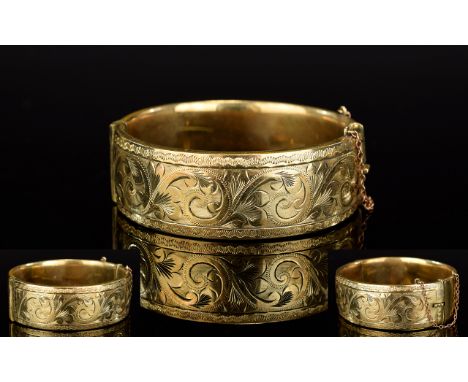Antique 9ct Gold And Metal Core Bangle Late 19th/early 20th century wide clasp bangle with attached safety chain and machine 