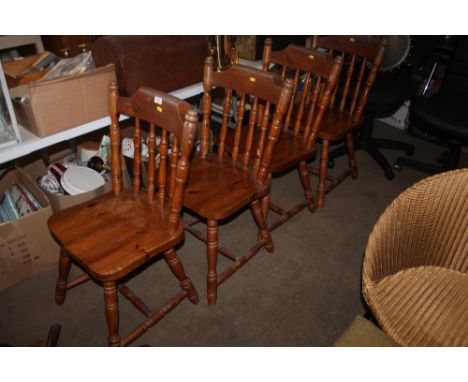 A set of four pine stick back dining chairs