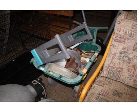A plastic garden wheelbarrow and contents of various hand tools etc