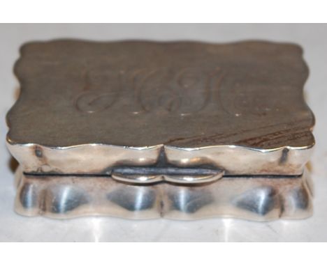 An early 20th century silver snuff box of shaped rectangular form with presentation inscription verso, Sheffield assays