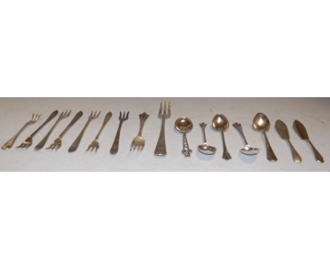 A small collection of silver flatwares to include butter knife, teaspoons, pickle fork etc