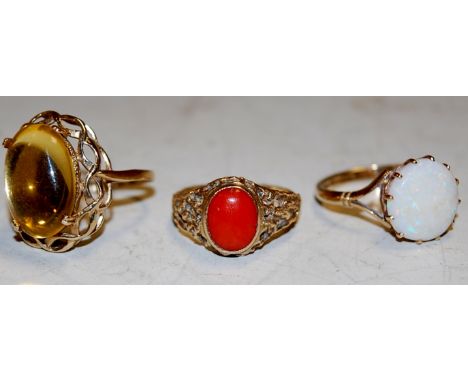 A ladies 9ct gold opal set dress ring, together with a 9ct gold citrine set ring, and one other, 10.9g (3) Condition Report /