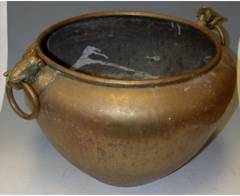 An early 20th century eastern brass jardiniere with ring mask handles
