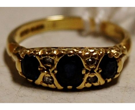 A ladies 18ct gold, sapphire and diamond point set dress ring 