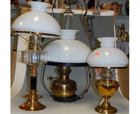 A Victorian style iron framed ceiling light fitting having opalescent shade and brass reservoir together with two others (3)