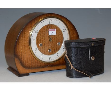 An Art Deco oak cased mantel clock; together with a pair of cased Russian binoculars (2)