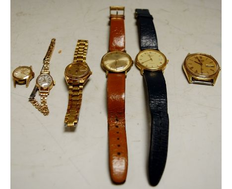 A Tissot yellow metal cased ladies wrist watch on a flexible link strap together with various others