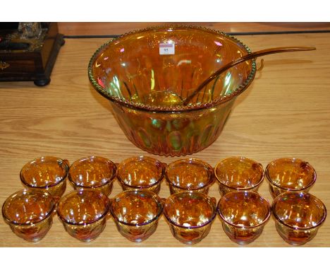 A carnival glass style punch bowl with 12 matching punch cups and ladle