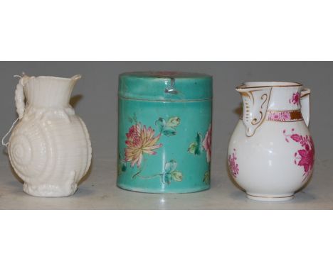 A first period Belleek shell shaped jug; together with a Herend porcelain jug; and a Chinese style green glazed jar and cover