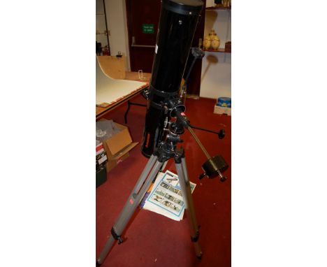 A Celestron First Scope 114 telescope on tripod