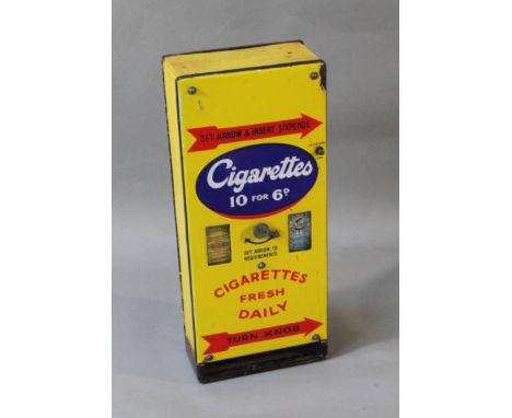 A vintage 'Cigarettes Fresh Daily' enamel cigarette vending machine, pre 1940, 'Cigarettes 10 FOR 6d', the interior with labe