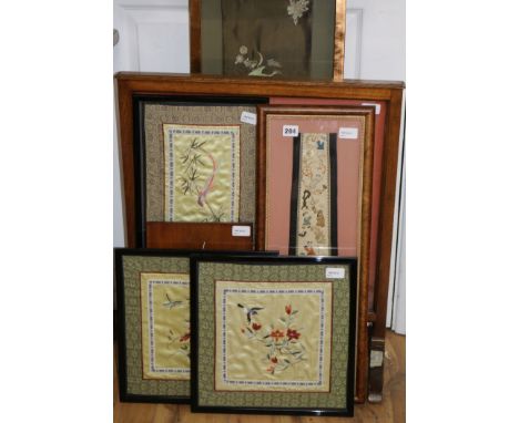 Six Chinese silk embroidered framed panels, comprising a firescreen inset with a stumpwork dragon, a box-framed sleeve panel 