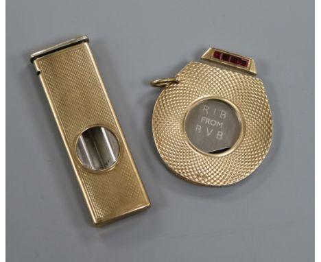 Two engine turned 9ct. gold mounted cigar cutters.