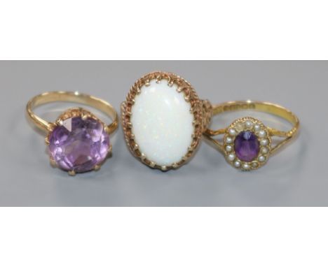 An Edwardian 9ct gold, amethyst and seed pearl set dress ring and two other later 9ct gold gem set rings including white opal