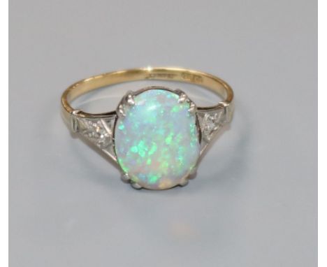 A 1920's 18ct gold, black opal ring with diamond set shoulders, (opal chipped), size L.