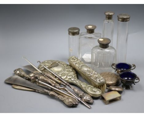 A mixed quantity of silver items including toilet jars, shoe horns, button hooks and two silver salts and a silver plated han